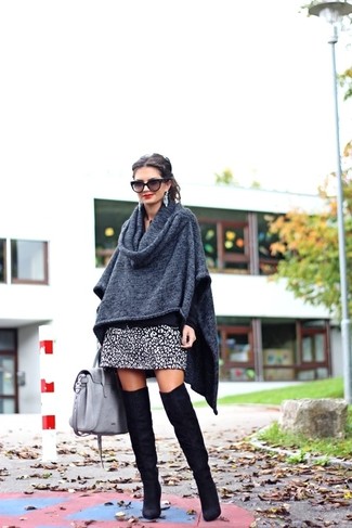 White and Black Leopard Mini Skirt Outfits: Wear a charcoal poncho with a white and black leopard mini skirt to pull together an interesting and modern-looking laid-back outfit. For something more on the sophisticated end to round off this ensemble, complete your outfit with a pair of black suede over the knee boots.