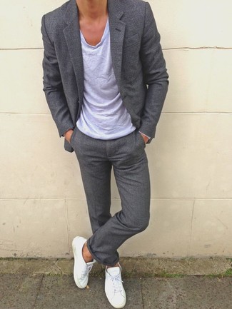 Put the dandy mode on in a charcoal suit and a grey crew-neck t-shirt. Puzzled as to how to finish? Complement your ensemble with a pair of white low top sneakers to switch things up.