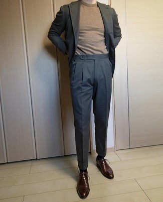 Tan Crew-neck Sweater Outfits For Men: A tan crew-neck sweater and a charcoal suit are absolute staples if you're figuring out a sophisticated closet that holds to the highest men's style standards. Bump up your look by slipping into dark brown leather oxford shoes.