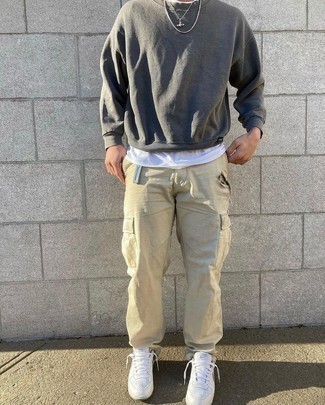 Charcoal Sweatshirt Outfits For Men: Fashionable and functional, this casual combo of a charcoal sweatshirt and beige cargo pants will provide you with variety. A pair of white leather low top sneakers is a smart option to finish this outfit.