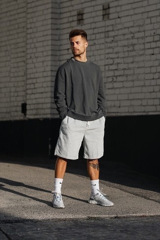 Charcoal Sweatshirt Outfits For Men: For a winning laid-back option, you can rely on this pairing of a charcoal sweatshirt and white seersucker shorts. Get a little creative when it comes to footwear and make grey athletic shoes your footwear choice.