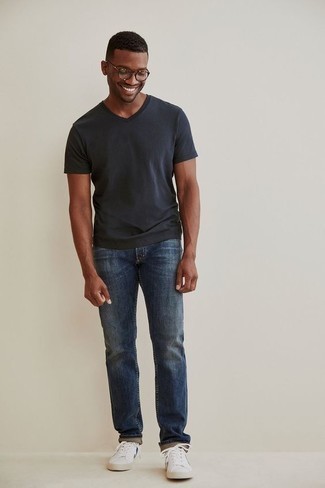 Charcoal V-neck T-shirt Outfits For Men: This combination of a charcoal v-neck t-shirt and blue jeans is beyond versatile and provides a casually cool look. Let your outfit coordination skills truly shine by completing your outfit with a pair of white canvas low top sneakers.