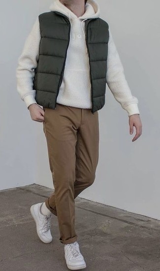 Men's White Leather Low Top Sneakers, Brown Chinos, White Fleece Hoodie, Dark Green Quilted Gilet