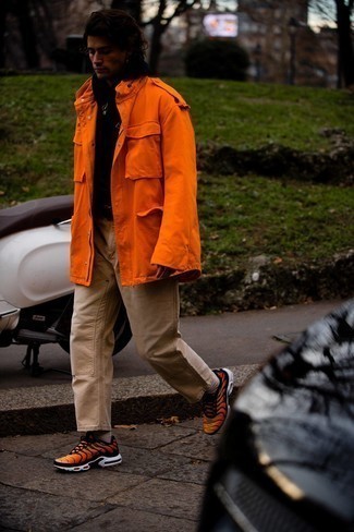Men's Orange Athletic Shoes, Khaki Chinos, Black Hoodie, Orange Military Jacket