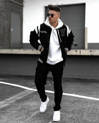 Men's White Canvas Low Top Sneakers, Black Chinos, White Hoodie, Black and White Varsity Jacket