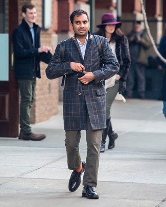 Aziz Ansari wearing Black Leather Derby Shoes, Olive Chinos, Light Blue Vertical Striped Long Sleeve Shirt, Navy Plaid Overcoat