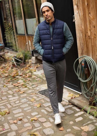 Men's White Canvas Low Top Sneakers, Grey Chinos, Teal Sweatshirt, Navy Quilted Gilet