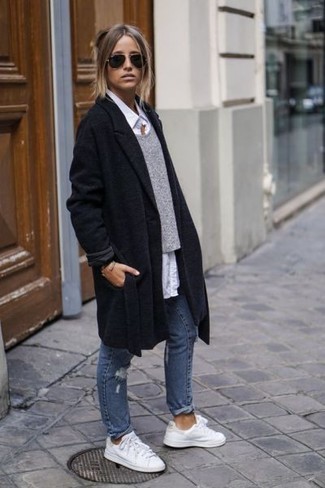 Black Coat Outfits For Women: If you're on a mission for a casual yet chic look, reach for a black coat and blue ripped jeans. A pair of white leather low top sneakers adds just the right amount of casualness to this look.