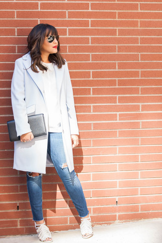 White Crew-neck Sweater Outfits For Women: Master the casually stylish look by opting for a white crew-neck sweater and blue ripped skinny jeans. You could stick to a more elegant route with footwear with a pair of white fringe leather heeled sandals.