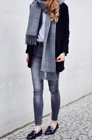 Tassel Loafers Outfits For Women: For a casual and cool look, pair a black coat with grey skinny jeans — these two pieces fit really well together. Tassel loafers will be a stylish companion for your ensemble.
