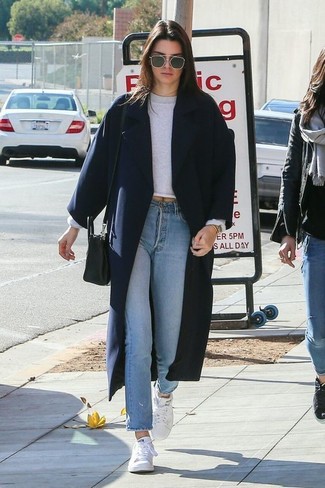 White Canvas Low Top Sneakers Outfits For Women: Pairing a navy coat with light blue jeans is an on-point choice for a casual and cool outfit. Don't know how to round off? Complement this look with a pair of white canvas low top sneakers to spice things up.