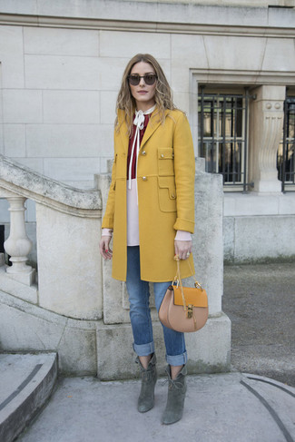Olivia Palermo wearing Mustard Coat, Burgundy Long Sleeve Blouse, Blue Jeans, Dark Green Suede Ankle Boots