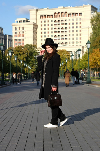 Black Pajama Pants Outfits For Women: This off-duty pairing of a black coat and black pajama pants can only be described as strikingly stylish. And if you wish to easily play down this getup with a pair of shoes, complement your outfit with white canvas low top sneakers.