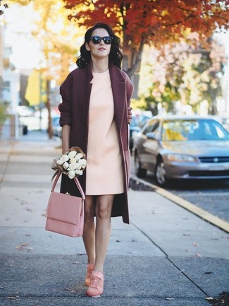 Burgundy Coat Outfits For Women: This combination of a burgundy coat and a beige shift dress flirts with formal and relaxed. Why not complement your outfit with a pair of pink low top sneakers for a touch of stylish nonchalance?