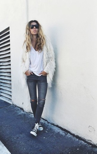 Black High Top Sneakers Outfits For Women: This combination of a white textured coat and charcoal ripped skinny jeans is effortless, incredibly stylish and oh-so-easy to replicate! Finishing off with a pair of black high top sneakers is a surefire way to infuse a dose of playfulness into this ensemble.