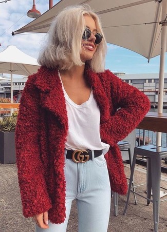 Light Blue Jeans Outfits For Women: Effortlessly blurring the line between elegant and off-duty, this combination of a red fluffy coat and light blue jeans is sure to become your go-to.