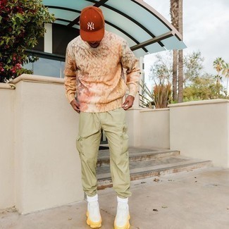 Orange Baseball Cap Outfits For Men: Marrying a beige print crew-neck sweater with an orange baseball cap is a savvy pick for an off-duty but on-trend getup. With footwear, go for something on the more elegant end of the spectrum and complete your outfit with white athletic shoes.