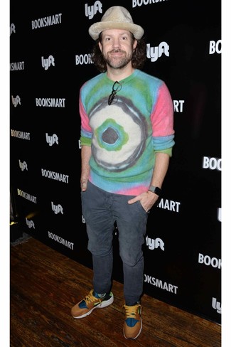Jason Sudeikis wearing Multi colored Tie-Dye Crew-neck Sweater, Charcoal Chinos, Multi colored Athletic Shoes, Beige Wool Hat