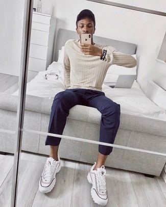 White and Black Athletic Shoes Outfits For Men: This combo of a beige crew-neck sweater and navy chinos is proof that a pared down casual outfit can still be really stylish. Put a fresh spin on an otherwise traditional outfit by finishing with white and black athletic shoes.