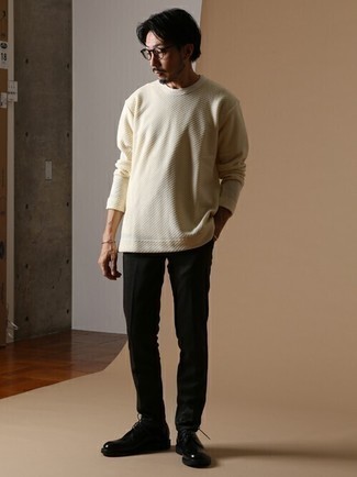 Tan Crew-neck Sweater Outfits For Men: If you gravitate towards off-duty outfits, why not wear this combination of a tan crew-neck sweater and black chinos? Make your ensemble a bit sleeker by finishing with black leather derby shoes.