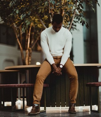 Brown Leather Desert Boots Outfits: Reach for a white crew-neck sweater and brown chinos for comfort dressing with a twist. Complete your look with a pair of brown leather desert boots for maximum effect.