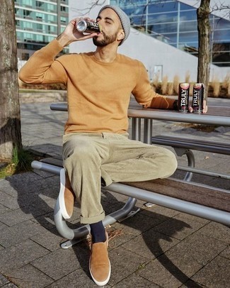 Tan Suede Slip-on Sneakers Outfits For Men: Super stylish and functional, this relaxed casual combination of a tan crew-neck sweater and beige corduroy chinos delivers wonderful styling opportunities. If you're puzzled as to how to round off, a pair of tan suede slip-on sneakers is a never-failing option.