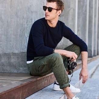 Olive Cargo Pants Outfits: You'll be surprised at how easy it is for any gent to pull together this casual outfit. Just a navy crew-neck sweater and olive cargo pants. White and navy canvas low top sneakers tie the ensemble together.