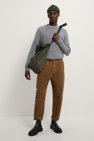 Brown Corduroy Chinos Outfits In Their 20s: Pair a grey crew-neck sweater with brown corduroy chinos for a relaxed menswear style with a modern twist. Want to go all out with shoes? Introduce a pair of black leather chelsea boots to your ensemble. That's the look for a 20-year-old guy to portray you've got what it takes to go places.