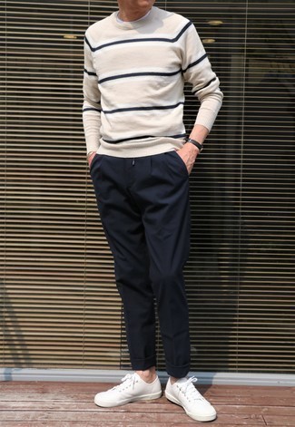 Horizontal Striped Crew-neck Sweater Outfits For Men: Teaming a horizontal striped crew-neck sweater with navy chinos is a smart idea for an off-duty outfit. White canvas low top sneakers look perfectly at home with this look.