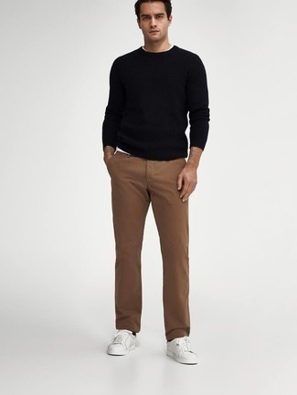 Black Crew-neck Sweater Outfits For Men: A black crew-neck sweater and brown chinos are wonderful menswear essentials that will integrate perfectly within your current casual repertoire. To give your overall ensemble a more relaxed aesthetic, complement this outfit with white leather low top sneakers.