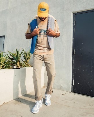 Tan Print Crew-neck T-shirt Outfits For Men: Go for a tan print crew-neck t-shirt and khaki ripped jeans to put together a truly sharp and bold casual ensemble. All you need now is a pair of light blue leather high top sneakers to finish this ensemble.