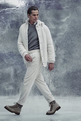 500+ Outfits For Men After 40: This combination of a grey crew-neck sweater and white chinos is a safe and very fashionable bet. Tone down the classiness of this outfit with grey suede work boots. This getup shows that as a 40-something guy, you have a wide range of styling options.