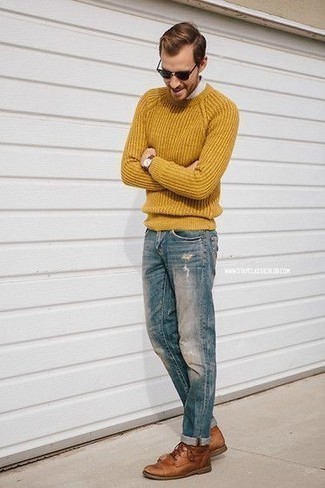 Orange Crew-neck Sweater Outfits For Men: Dress in an orange crew-neck sweater and blue ripped jeans for equally dapper and easy-to-wear ensemble. Give an extra dose of elegance to your outfit with brown leather desert boots.