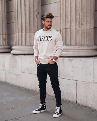 White and Black Print Crew-neck Sweater Outfits For Men: This off-duty combo of a white and black print crew-neck sweater and black ripped jeans is a real lifesaver when you need to look great in a flash. Let your sartorial chops really shine by finishing off your look with black and white canvas high top sneakers.