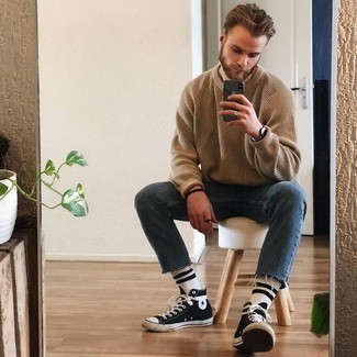 Beige Crew-neck Sweater Outfits For Men: Show off your credentials in men's fashion in this laid-back combo of a beige crew-neck sweater and navy jeans. Want to go easy in the shoe department? Introduce a pair of black and white canvas high top sneakers to the mix for the day.