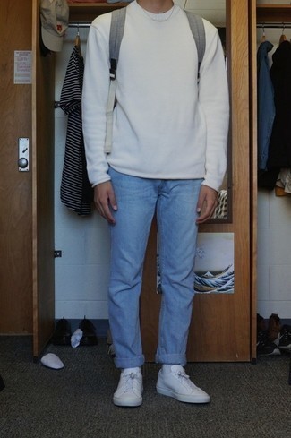 White Crew-neck Sweater Casual Outfits For Men: Fashionable and functional, this off-duty combo of a white crew-neck sweater and light blue jeans offers variety. On the footwear front, this outfit pairs nicely with white leather low top sneakers.