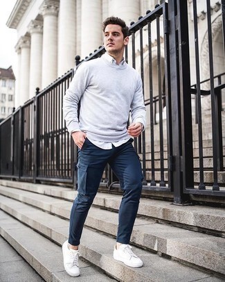 Navy Cargo Pants Outfits: A nicely pieced together combo of a grey crew-neck sweater and navy cargo pants will set you apart in an instant. The whole look comes together when you add white canvas low top sneakers to this getup.