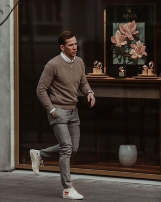 White Print Canvas High Top Sneakers Outfits For Men: Rock a brown crew-neck sweater with grey chinos if you wish to look casually stylish without spending too much time. For a more relaxed touch, why not throw white print canvas high top sneakers into the mix?