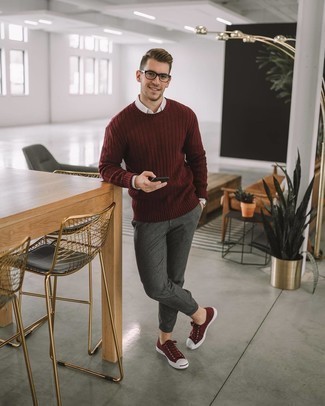 Red Canvas Low Top Sneakers Outfits For Men: Parade your credentials in menswear styling in this casual combo of a burgundy crew-neck sweater and charcoal chinos. A pair of red canvas low top sneakers immediately turns up the wow factor of this ensemble.