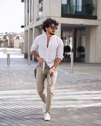 White Linen Long Sleeve Shirt Outfits For Men: If you're on a mission for a laid-back and at the same time stylish look, reach for a white linen long sleeve shirt and beige chinos. White canvas low top sneakers will effortlessly play down a dressy outfit.