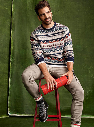 Tan Fair Isle Crew-neck Sweater Outfits For Men: This combination of a tan fair isle crew-neck sweater and beige jeans is the perfect foundation for a cool and relaxed look. You can get a bit experimental in the footwear department and complement this getup with a pair of black leather work boots.