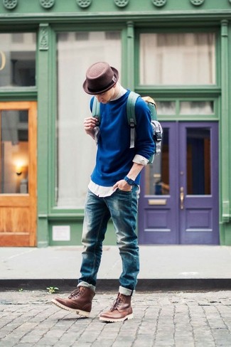 Brown Hat Outfits For Men: This off-duty combo of a navy crew-neck sweater and a brown hat is a goofproof option when you need to look great but have no time to dress up. For extra style points, complement this outfit with brown leather casual boots.