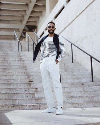 White and Black Horizontal Striped Long Sleeve T-Shirt Spring Outfits For Men: Pair a white and black horizontal striped long sleeve t-shirt with white chinos to don a laid-back and cool ensemble. A pair of white leather low top sneakers acts as the glue that will pull this outfit together. Keep this combo in mind when spring comes, and rest assured, you'll save a lot of time getting dressed on more than one occasion.
