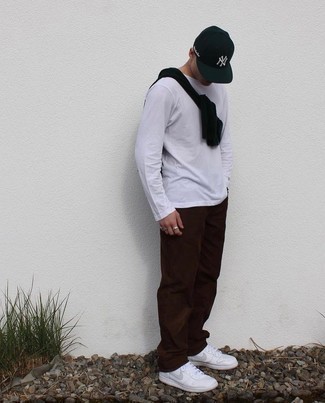 Dark Green Print Baseball Cap Outfits For Men: Opt for a black crew-neck sweater and a dark green print baseball cap if you seek to look laid-back and cool without trying too hard. Got bored with this getup? Introduce white leather low top sneakers to spice things up.