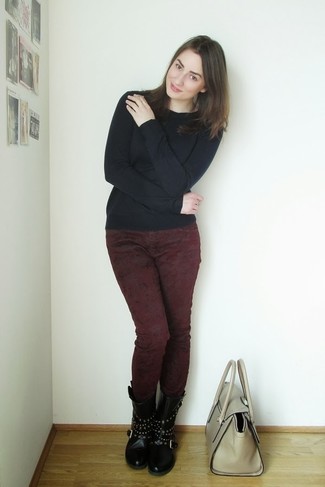 Burgundy Skinny Jeans Outfits: If you'd like take your off-duty fashion game to a new height, opt for a black crew-neck sweater and burgundy skinny jeans. When this look is too much, dress it down with a pair of black studded leather lace-up flat boots.