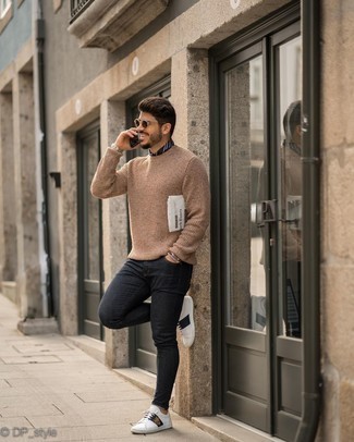 Tan Crew-neck Sweater Outfits For Men: If you don't like getting too predictable with your looks, consider wearing a tan crew-neck sweater and black skinny jeans. Complete this look with a pair of white print leather low top sneakers to tie your full ensemble together.