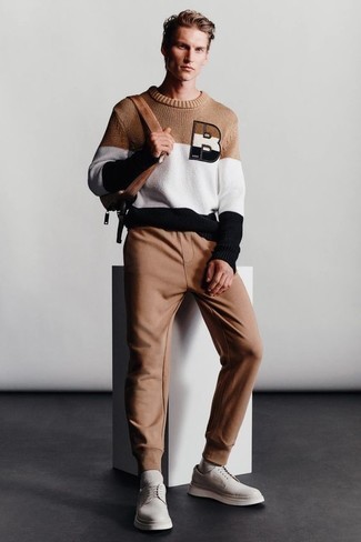Brown Sweatpants Outfits For Men: For relaxed dressing with a city style finish, choose a multi colored embroidered crew-neck sweater and brown sweatpants. Balance this outfit with a smarter kind of footwear, like this pair of white leather derby shoes.