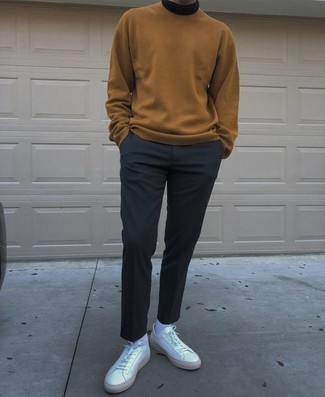 Beige Crew-neck Sweater Casual Outfits For Men: Consider teaming a beige crew-neck sweater with navy chinos for comfort dressing with a modernized spin. Puzzled as to how to round off? Complete this getup with white leather low top sneakers to spice things up.