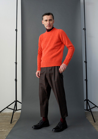 Brown Plaid Chinos Outfits: For something on the casually edgy side, dress in an orange crew-neck sweater and brown plaid chinos. A trendy pair of black leather derby shoes is an effective way to punch up your ensemble.