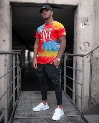 Multi colored Tie-Dye Crew-neck T-shirt Outfits For Men: A multi colored tie-dye crew-neck t-shirt and black cargo pants are a good pairing to keep in your closet. White athletic shoes will bring a hint of stylish effortlessness to an otherwise sober ensemble.